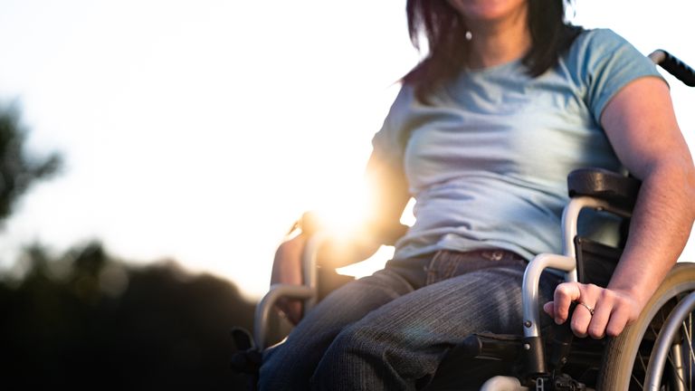 Close up of unrecognizable women in wheelchair outdoors