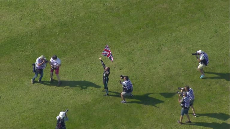 Hamilton celebrated with the British fans after winning a dramatic British GP by passing Charles Leclerc in the closing stages