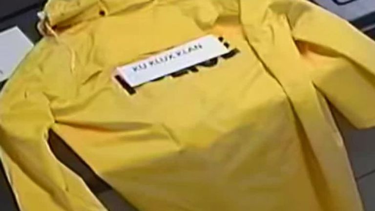 CCTV shows a Ohio police chief placing a sign with the works &#39;Ku Klux Klan&#39; on his colleague&#39;s coat.