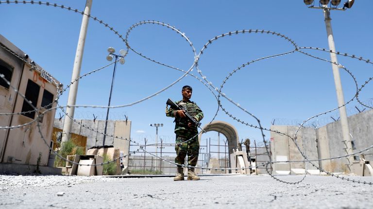 An Afghan soldier stands guard at Bagram airbase as the last US troops pulled out
