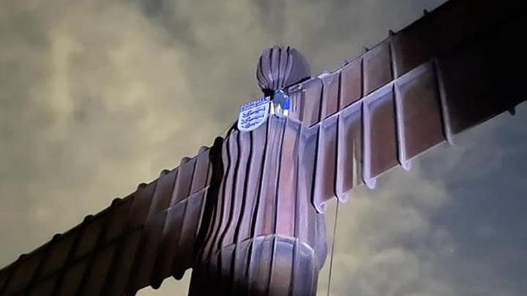 Handout photo of Ben Fada attempting to put an England badge on the Angel of the North 