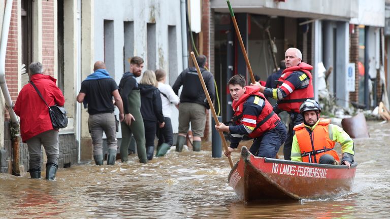 Austrian rescue team members pole their boat as they go through an area affected by floods, following heavy rainfalls, in Pepinster, Belgium, July 16, 2021. REUTERS/Yves Herman