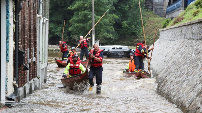 Austrian rescue team members use boats as they go through a flooded street in an area affected by floods, following heavy rainfalls, in Pepinster, Belgium, July 16, 2021. REUTERS/Yves Herman