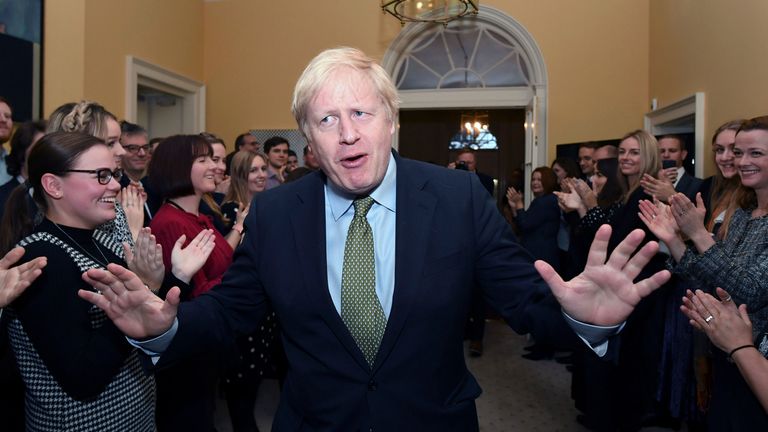 Prime Minister Boris Johnson is greeted by staff as he arrives back at 10 Downing Street, London, after meeting Queen Elizabeth II and accepting her invitation to form a new government after the Conservative Party was returned to power in the General Election with an increased majority. PA Photo. Picture date: Friday December 13, 2019. See PA story POLITICS Election. Photo credit should read: Stefan Rousseau/PA Wire