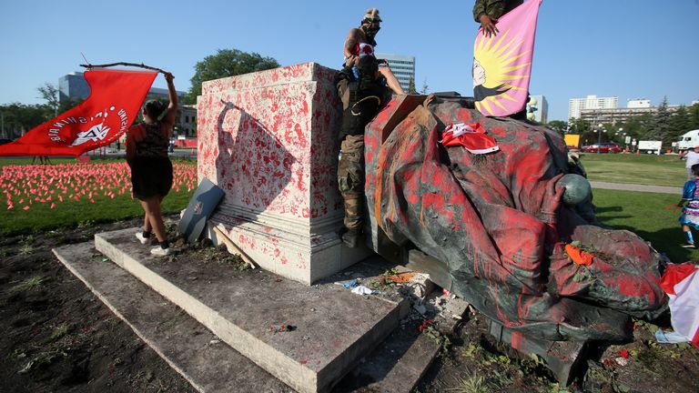 A defaced statue of Queen Victoria lies after being toppled during a rally, following the discovery of the remains of hundreds of children at former indigenous residential schools, outside the provincial legislature on Canada Day in Winnipeg, Manitoba, Canada July 1, 2021. REUTERS/Shannon VanRaes
