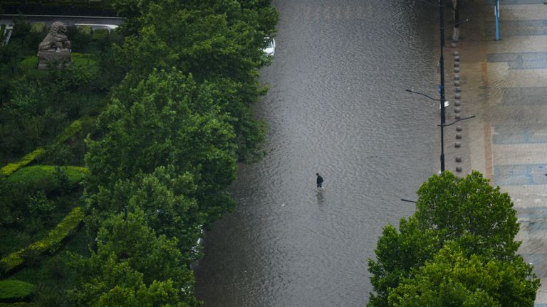 A person walks in the waterlogging caused by rainstorm in Zhengzhou city, central China&#39;s Henan province, 20 July 2021. (Imaginechina via AP Images)


