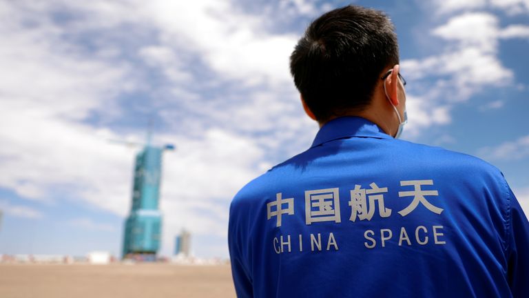 A staff member stands in front of the launch pad at Jiuquan Satellite Launch Center ahead of the Shenzhou-12 mission to build China&#39;s space station, near Jiuquan, Gansu province, China June 16, 2021