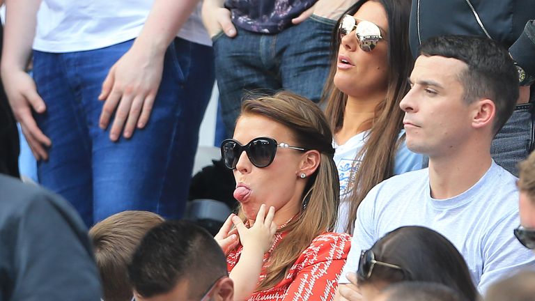 Coleen Rooney entertains her kids during the UEFA European Championship 2016; Rebekah Vardy sits behind her. Pic: AP
