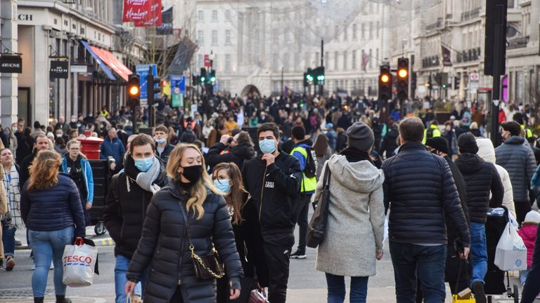 London, United Kingdom - December 5 2020: People wearing protective face masks walking on Regent Street, which was closed to vehicle traffic for a day.