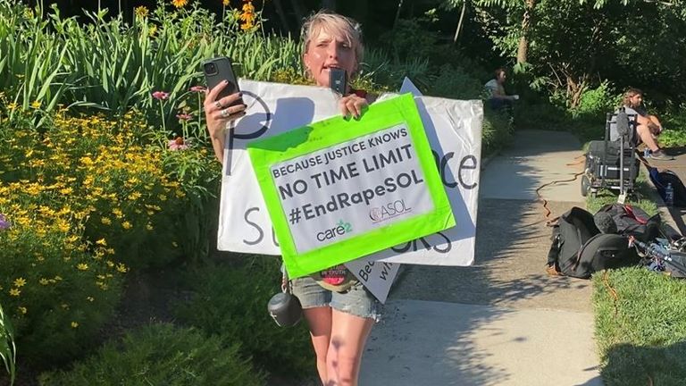 A woman protests against the release of bill Cosby outside his Pennsylvania home 