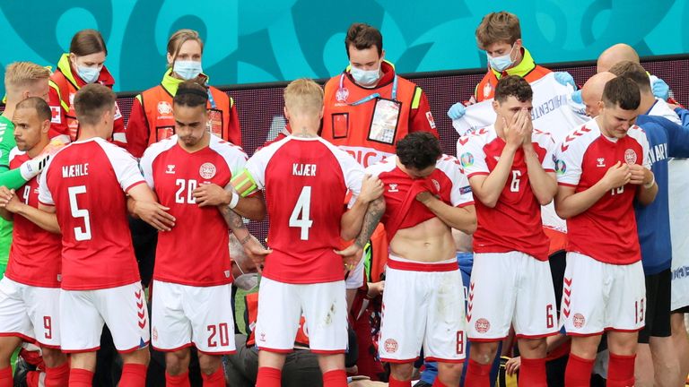 Denmark players formed a ring around Christian Eriksen as he received medical attention