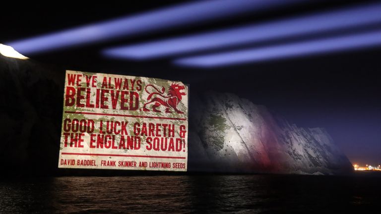 A good luck message from David Baddiel, Frank Skinner and the Lightning Seeds, writers of the song Three Lions, projected onto the White Cliffs of Dover