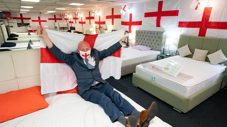 Noel Barton in his store VIP Beds in Birmingham, which he has covered in around 400 England flags