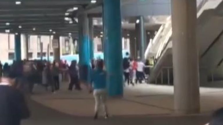 Fans seen running towards a staircase at Wembley