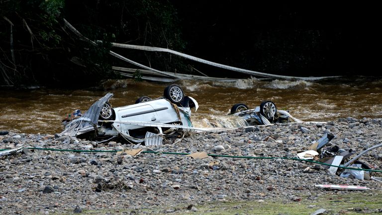 Two cars sit upside down in the Meuse River after flooding in Drolenvol, Belgium, Saturday, July 17, 2021. Residents in several provinces were cleaning up after severe flooding in Germany and Belgium turned streams and streets into raging torrents that swept away cars and caused houses to collapse. (AP Photo/Virginia Mayo)      