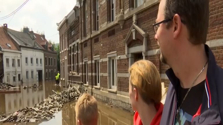 A family in Belgium return to their home after flooding 