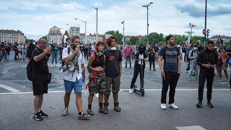 Protestors stand in front of policemen during a demonstration in Lyon, central France, Saturday, July 31, 2021. Demonstrators gathered in several cities in France on Saturday to protest against the COVID-19 pass, which grants vaccinated individuals greater ease of access to venues. (AP Photo/Laurent Cipriani)


