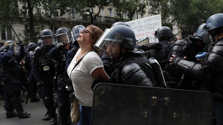 Police detain a protestor during a demonstration in Paris, France, Saturday, July 31, 2021. Demonstrators gathered in several cities in France on Saturday to protest against the COVID-19 pass, which grants vaccinated individuals greater ease of access to venues. (AP Photo/Adrienne Surprenant)


