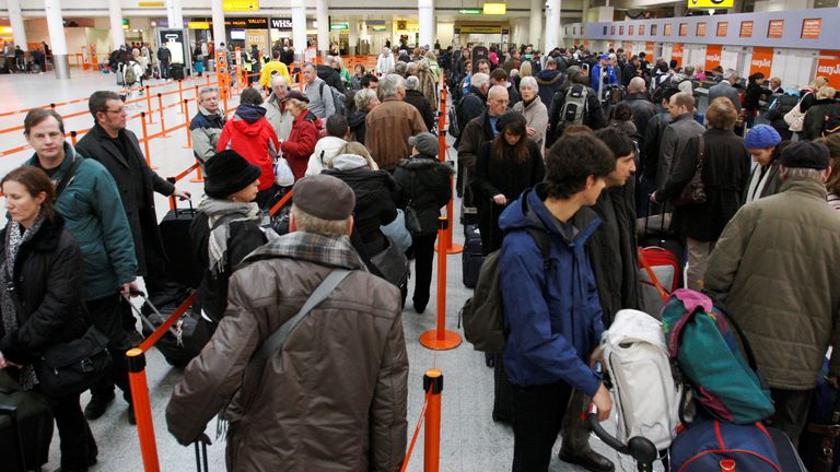 Passengers queue at check-in desks at Gatwick Airport
