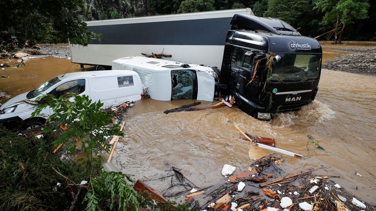 Partially submerged vehicles are pictured on a flood-affected area, following heavy rainfalls in Schuld, Germany, July 15, 2021. REUTERS/Wolfgang Rattay