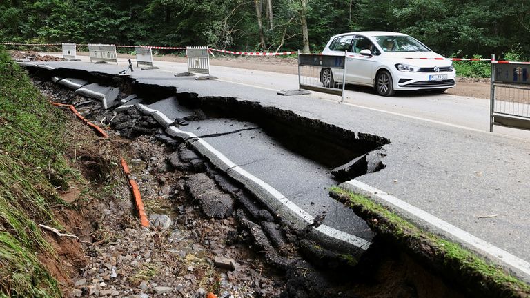A road is pictured collapsed as the result of flooding in Bad Muenstreifel