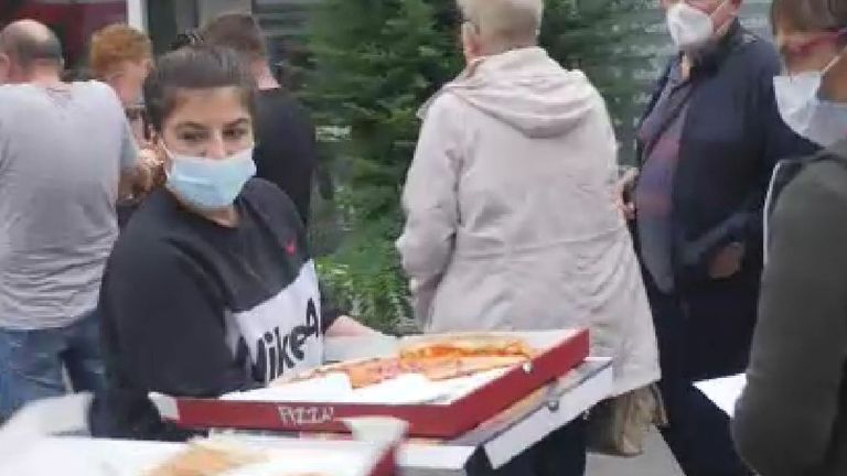 Pizza was offered to those queuing for cash handouts