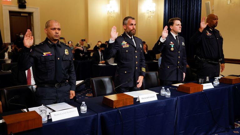 U.S. Capitol Police sergeant Aquilino Gonell; Washington DC Metropolitan Police Department officers Michael Fanone and Daniel Hodges, and U.S. Capitol Police Officer Harry Dunn are sworn in to testify during the opening hearing of the U.S. House (Select) Committee investigating the January 6 attack on the U.S. Capitol, on Capitol Hill in Washington, U.S., July 27, 2021. REUTERS/Jim Bourg/Pool