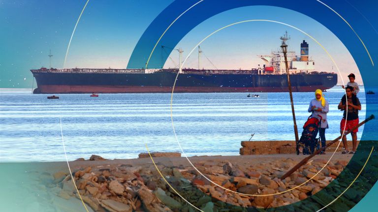 People walk on the beach as a container ship crosses the Gulf of Suez towards the Red Sea before entering the Suez Canal, in El Ain El Sokhna in Suez, east of Cairo, Egypt April 24, 2017. 
