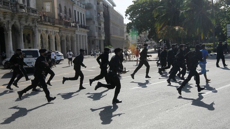 Police run during the protests