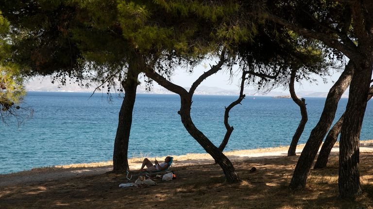 A man reads a book as he lies on a sun bed under pines at Varkiza village, a few miles southwest of Athens, on Thursday, July 29, 2021. One of the most severe heat waves recorded since 1980s scorched southeast Europe on Thursday, sending residents flocking to the coast, public fountains and air-conditioned locations to find some relief, with temperatures rose above 40 C (104 F) in parts of Greece and across much of the region. (AP Photo/Yorgos Karahalis)


