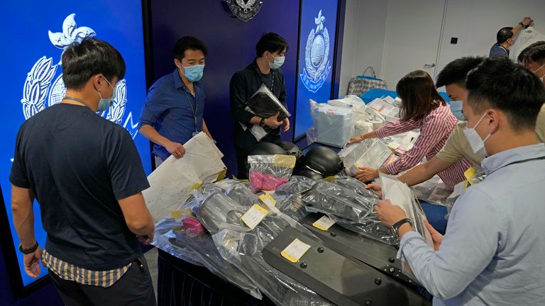Police officers display the confiscated evidence during a news conference. Pic: AP