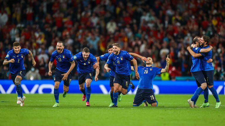 The Italians rush towards Jorginho after he sealed their place in the final. Pic: AP