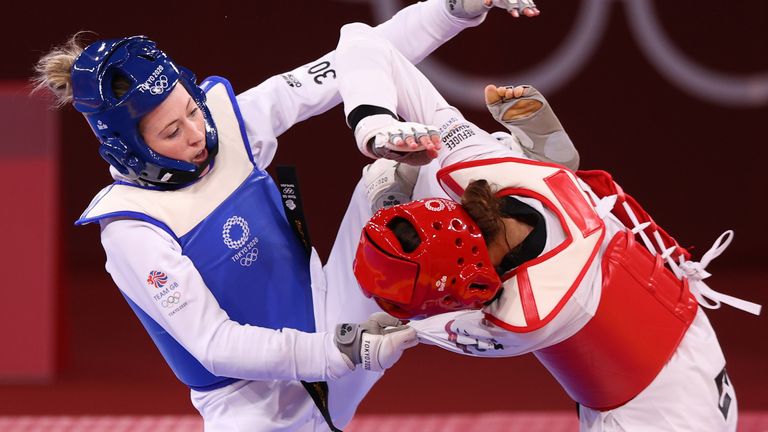 Tokyo 2020 Olympics - Taekwondo - Women&#39;s Featherweight 49-57kg - Last 16 - Makuhari Messe Hall A, Chiba, Japan - July 25, 2021. Jade Jones of Britain in action against Kimia Alizadeh of the Refugee Olympic Team REUTERS/Murad Sezer