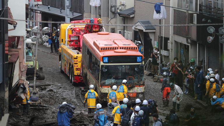 A wrecked bus is removed from debris flow site in Atami City, Shizuoka Prefecture on July 5, 2021. A large-scale mudslide triggered by torrential rain occurred in Atami on July 3rd, as a seasonal front brought heavy downpours to areas across the Kanto and Tokai regions. It is estimated that there are many dead and missing person.   ( The Yomiuri Shimbun via AP Images )