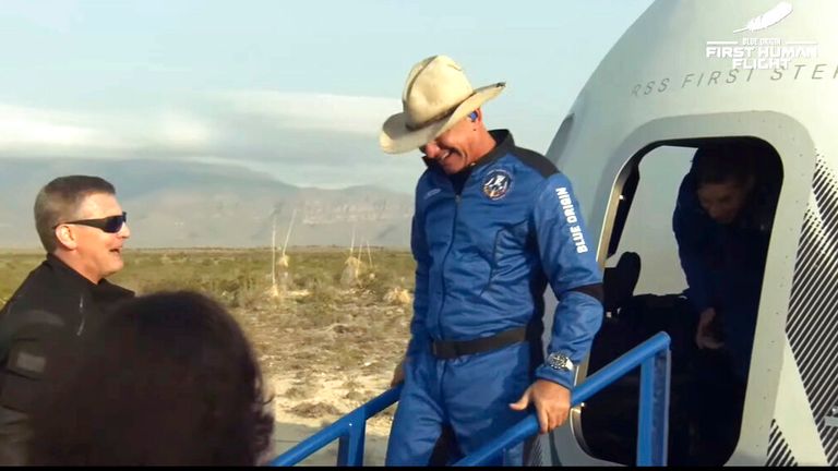 Mr Bezos grins as he leaves the capsule. Pic: AP/Blue Origin