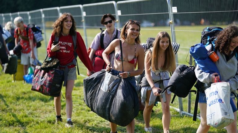 Festivalgoers arrive at the Latitude festival in Henham Park, Southwold, Suffolk. Picture date: Thursday July 22, 2021.