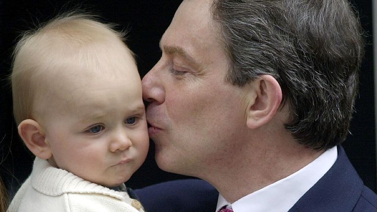 British Prime Minister Tony Blair kisses his youngest son Leo outside his official residence at 10 Downing Street, London, after winning the General Election and securing a historic second Labour landslide victory.
