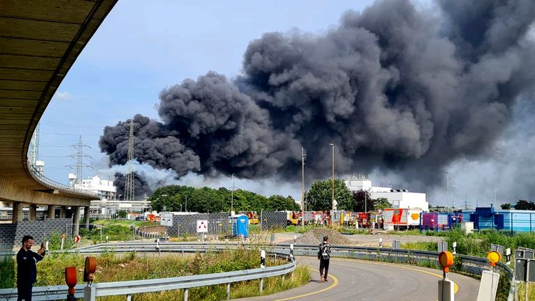 27 July 2021, North Rhine-Westphalia, Leverkusen: A dark cloud of smoke rises above the chemical park. Firefighters from the site fire department are on duty. Photo: Mirko Wolf/dpa