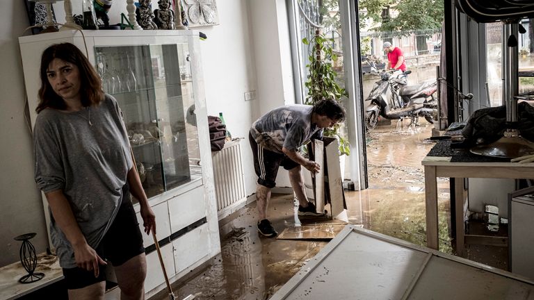 People clean their home in Liege, Belgium. Pic: Associated Press