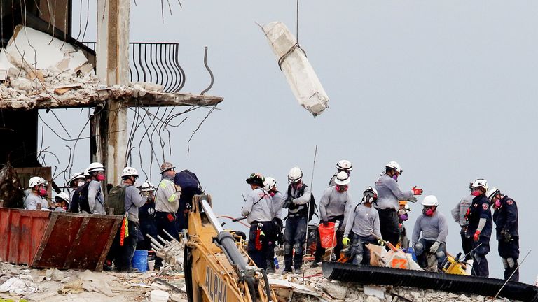 Emergency workers conduct search and rescue efforts at the site of a partially collapsed residential building in Surfside, near Miami Beach, Florida
