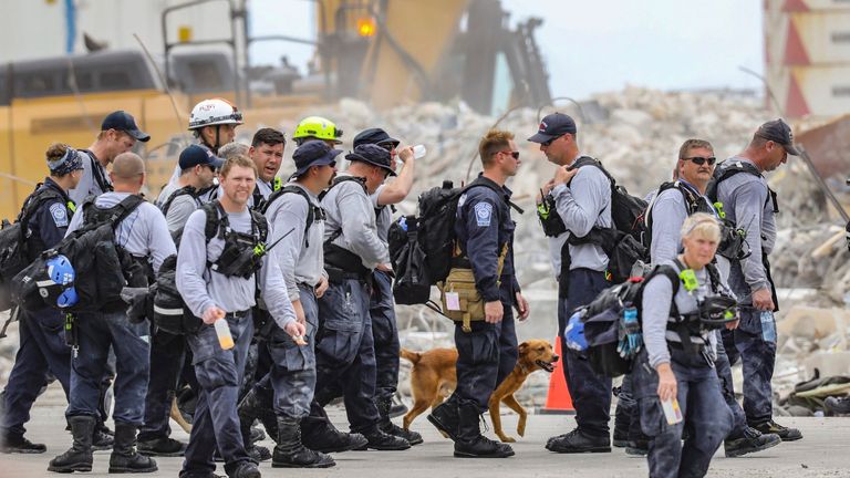 Search and rescue team members depart after working the debris field of the 12-story oceanfront condo, Champlain Towers South in Surfside on Wednesday, July 7, 2021. 