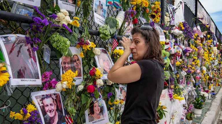 Gini Gonte visits the Surfside Wall of Hope & Memorial on Wednesday, July 7, 2021, as she honors her friends Nancy Kress Levin and Jay Kleiman, who lost their lives after the collapse of the Champlain Towers South in Surfside, Florida.  