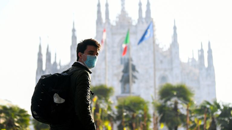 A man wearing a mask in Duomo Square, Milan. File pic