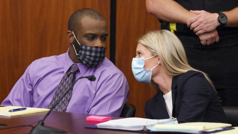 Defendant Nathaniel Rowland speaks with his lawyer, Alicia Goode, during his trial in Richland County Court