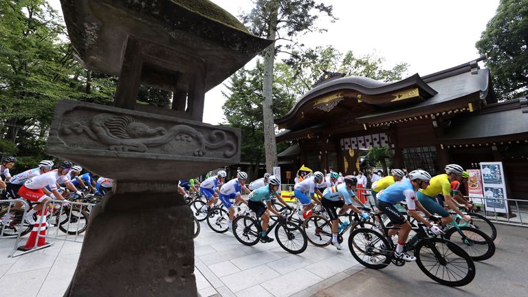 Tokyo 2020 Olympics - Cycling - Road - Men&#39;s Road Race - Final - Tokyo to Fuji International Speedway, Japan - July 24, 2021. Riders pass the Okunitama shrine REUTERS/Christian Hartmann