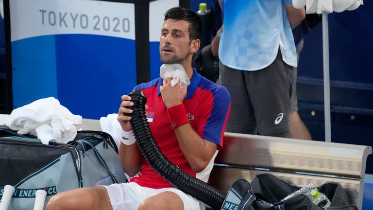 Novak Djokovic cools off between sets in the men&#39;s singles semi-finals 