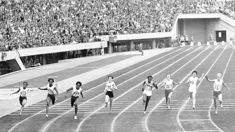 Tyus (third from left) finishing first in the 100m final in Tokyo