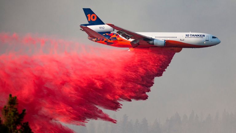 A plane drops retardant over the Bootleg fire, one of the largest wildfires in modern Oregon history