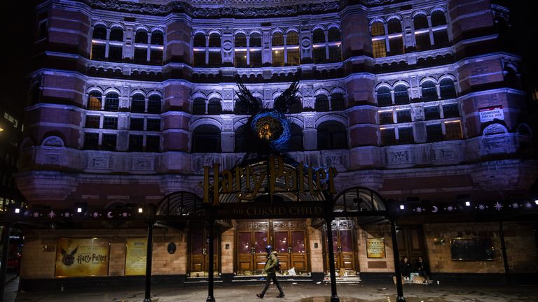 A man walks past the Palace Theatre in London, which is closed as the area has moved into the highest tier of coronavirus restrictions as a result of soaring case rates.