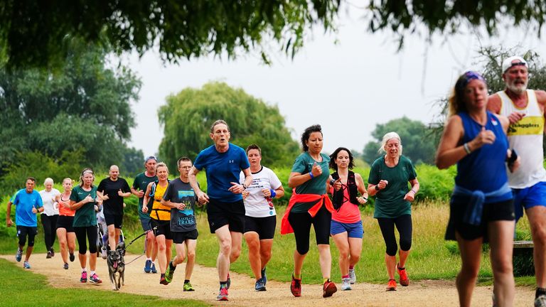 Runners taking part in the Parkrun at Bushy Park in London